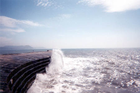 A wave strikes the Cobb at Lyme Regis.